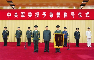 7月5日，中央軍委授予榮譽(yù)稱號(hào)儀式在北京隆重舉行。中央軍委主席習(xí)近平向獲得“反恐尖刀中隊(duì)”榮譽(yù)稱號(hào)的武警部隊(duì)新疆維吾爾自治區(qū)總隊(duì)某機(jī)動(dòng)支隊(duì)特戰(zhàn)大隊(duì)特戰(zhàn)1中隊(duì)頒授獎(jiǎng)旗，并同該中隊(duì)代表合影留念。 新華社記者 李剛 攝